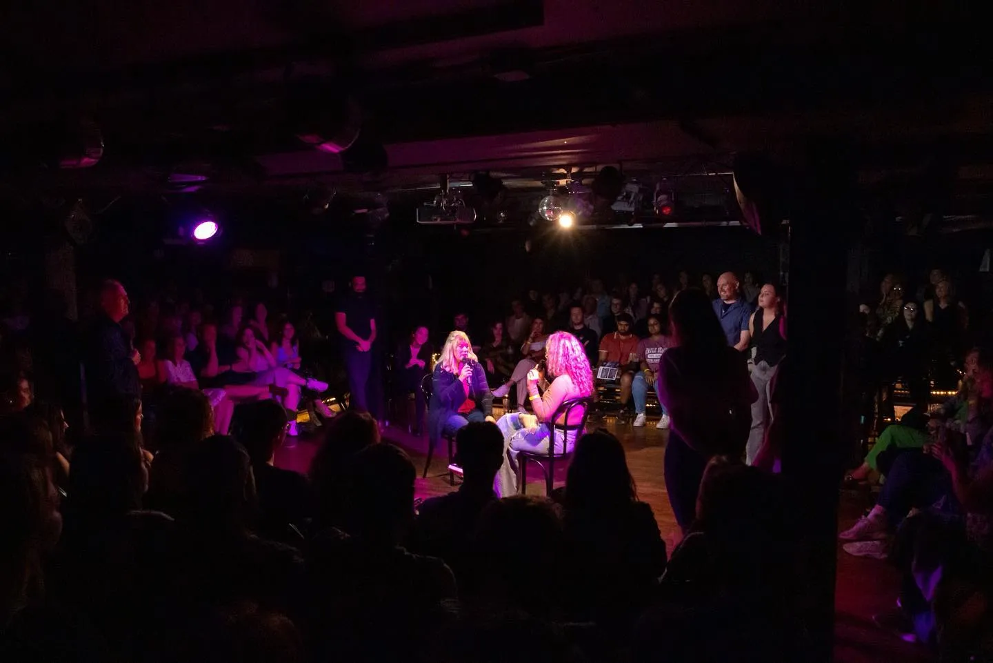 Packed comedy club enjoying a live psychic reading – Boston's funniest interactive improv event