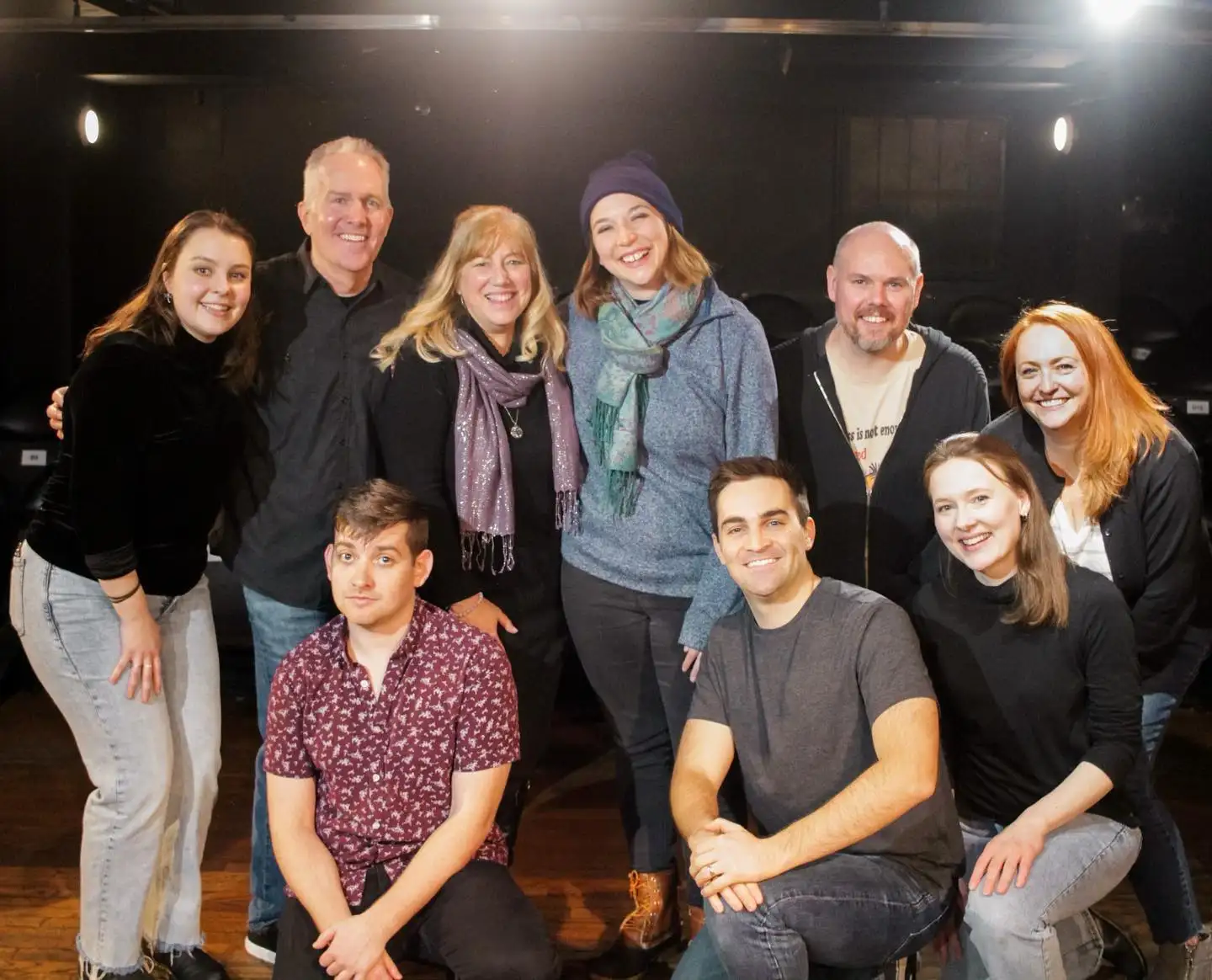 Cast of Psyched Out Comedy posing together on stage – live psychic improv show in Boston and New England